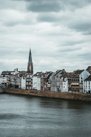 brown and white concrete buildings beside body of water during daytime