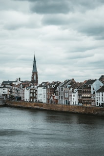 brown and white concrete buildings beside body of water during daytime