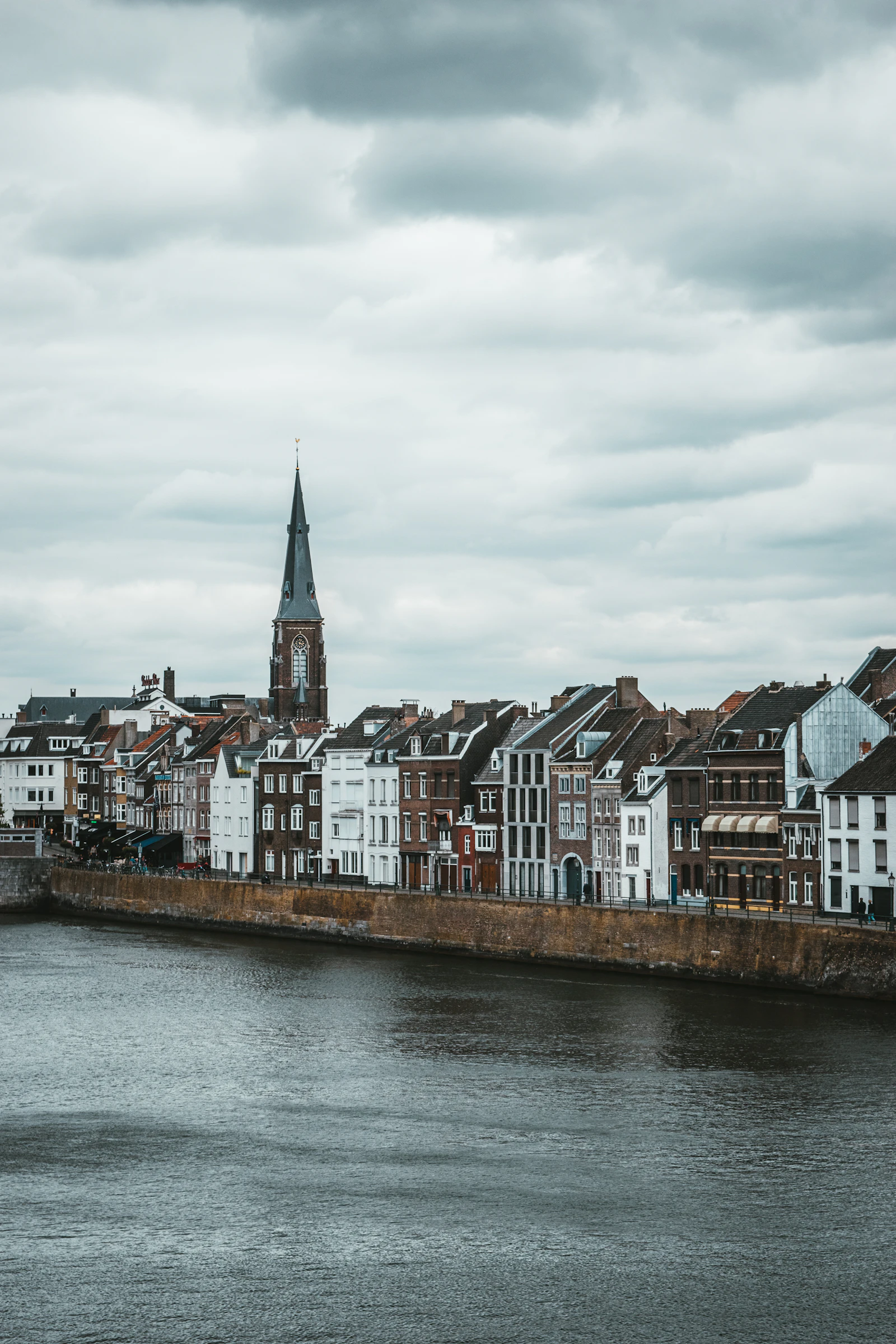 Historic quay and church tower along the Maas, Maastricht, Netherlands