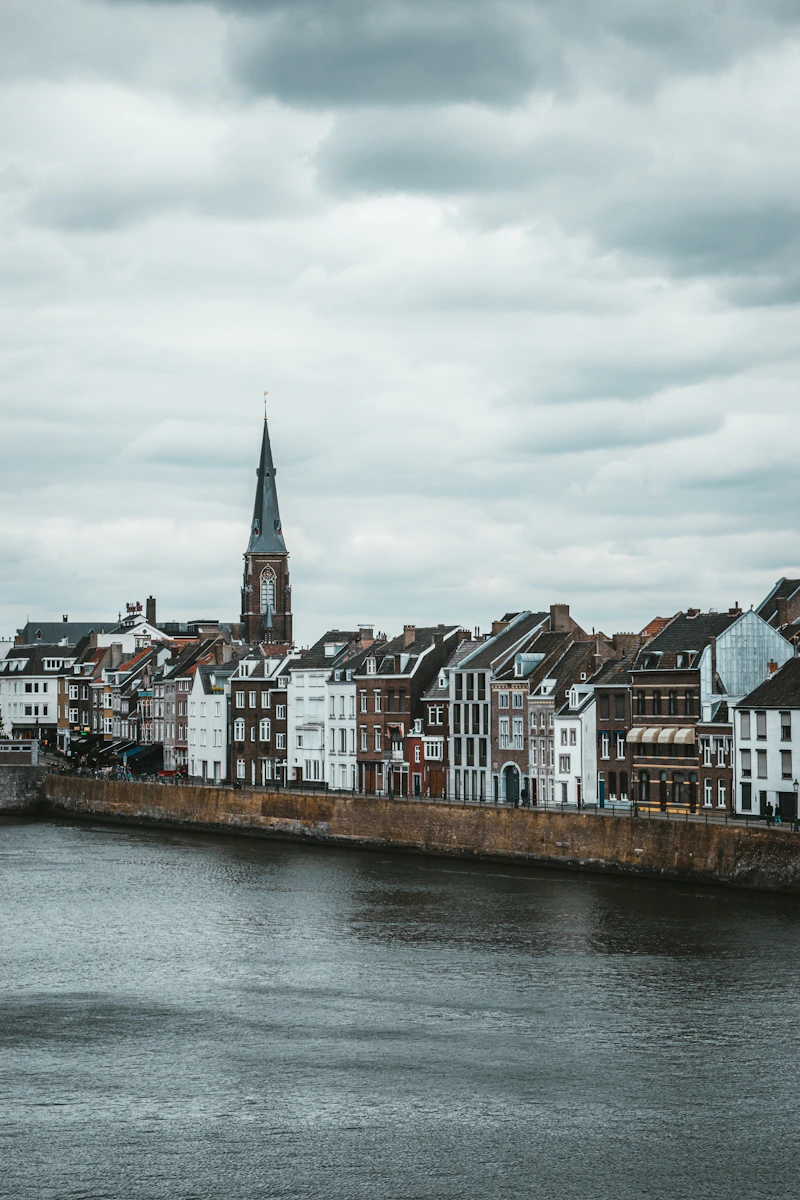 Historic quay and church tower along the Maas, Maastricht, Netherlands