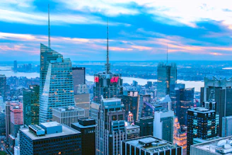 A modern city skyline with digital tokens floating above buildings, symbolizing real estate tokenization.