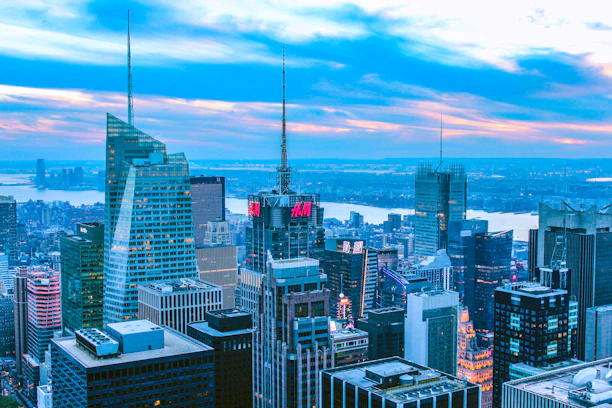 A modern city skyline with digital token icons floating above buildings, symbolizing real estate tokenization.