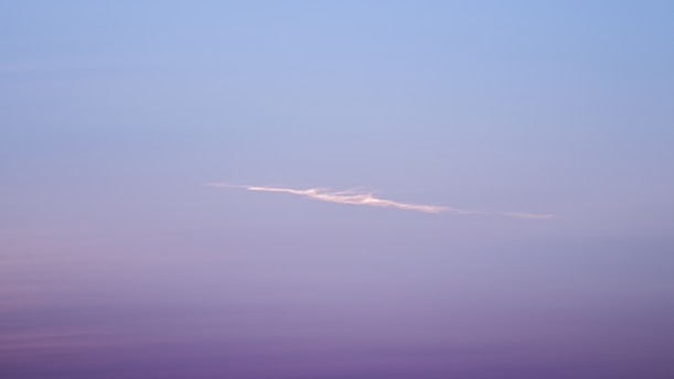 A serene blend of deep purple and blue hues with a subtle silhouette of Lord Shiva meditating under a starry sky.