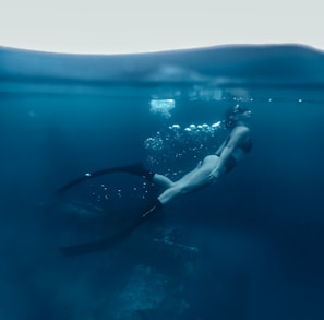 woman in black bikini swimming in the water