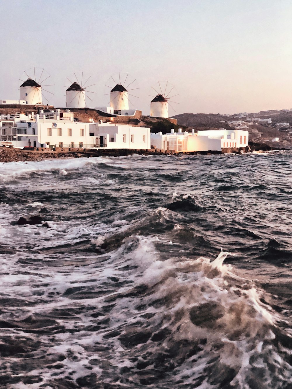 white and brown building on sea water