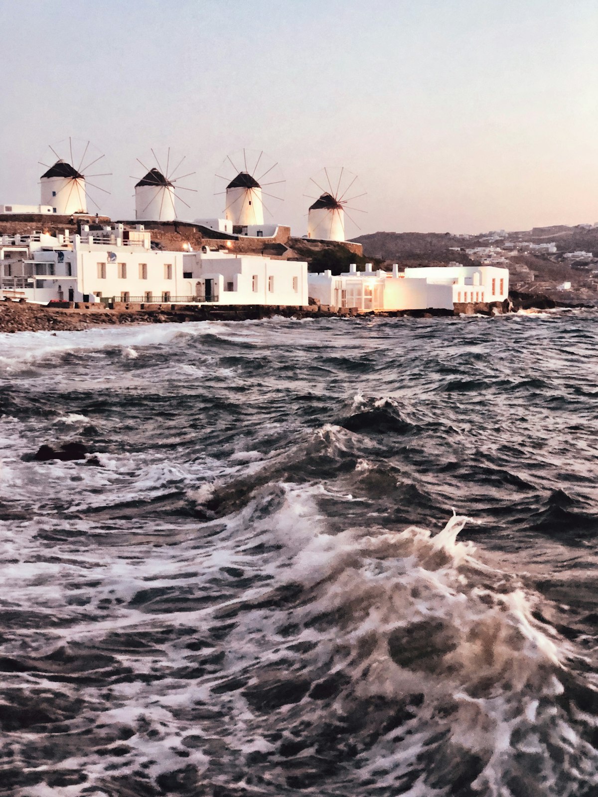 Mykonos Town Chora — the iconic whitewashed windmills above Little Venice at dusk