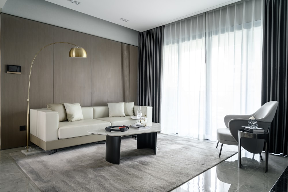 white sectional couch beside black wooden table