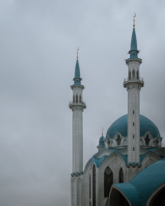 white and green concrete building under white sky during daytime in Kazan Kremlin, Qolsharif Mosque Russia