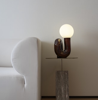 white and brown lamp on brown wooden table