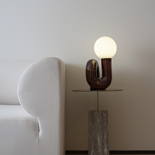 white and brown lamp on brown wooden table