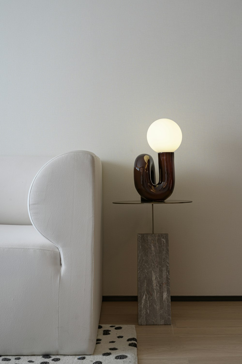 white and brown lamp on brown wooden table