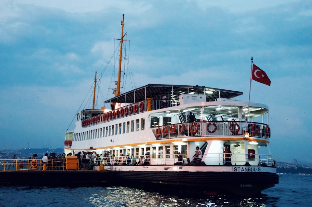 white and red ship on sea during daytime