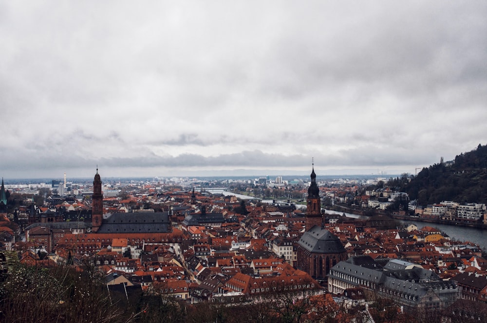 city with high rise buildings under white clouds during daytime