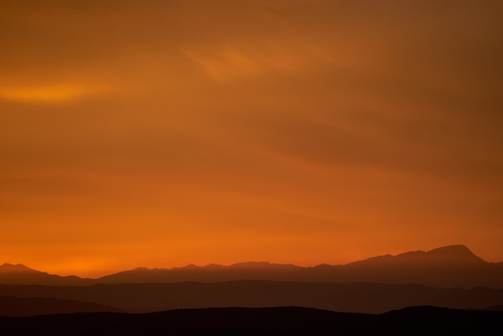 silhouette of mountains under blue sky during daytime