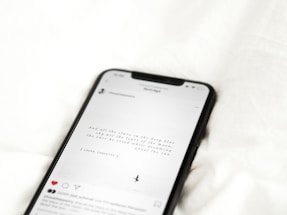 black android smartphone on white textile