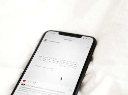 black android smartphone on white textile