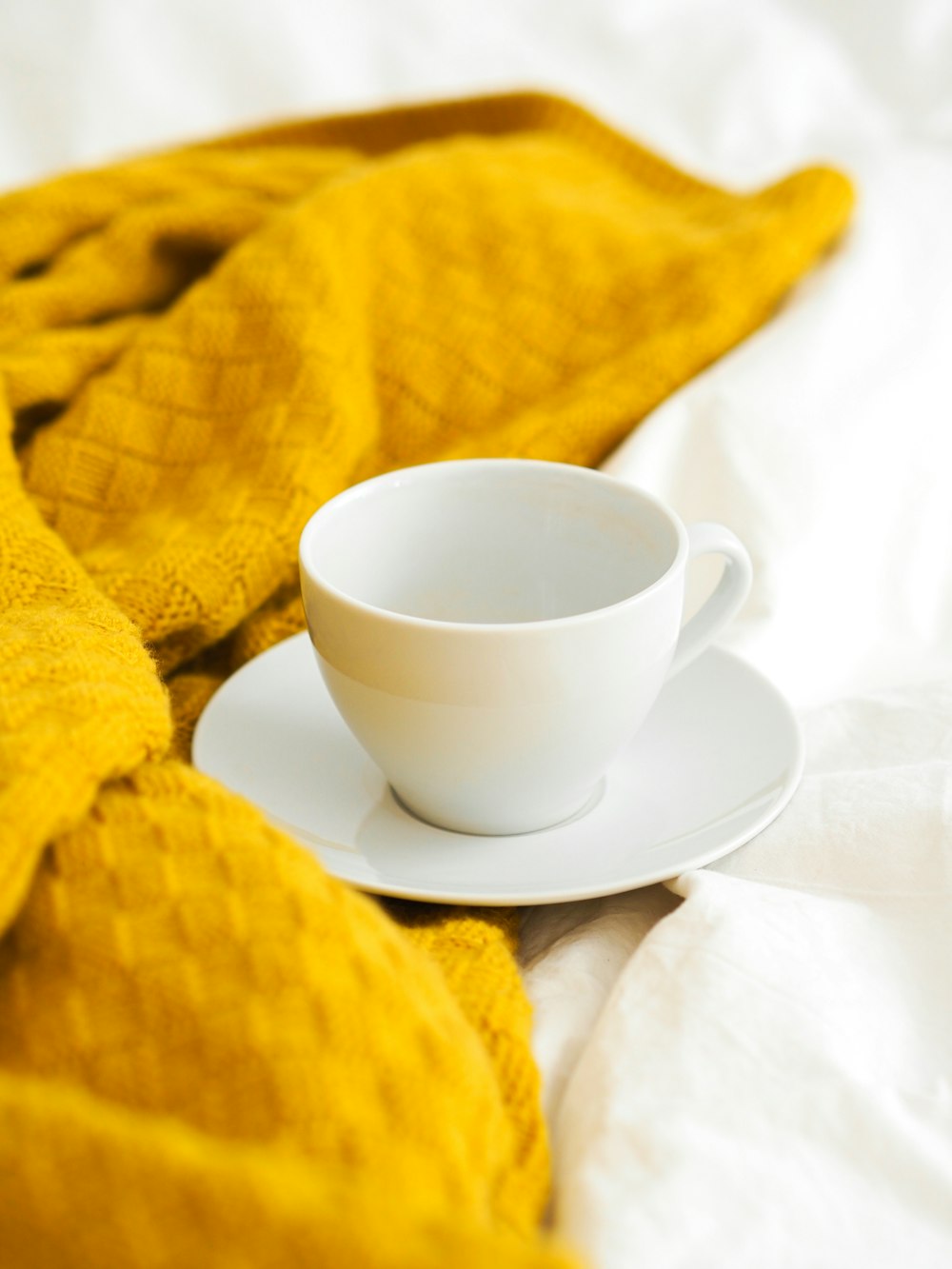 white ceramic teacup on white ceramic saucer