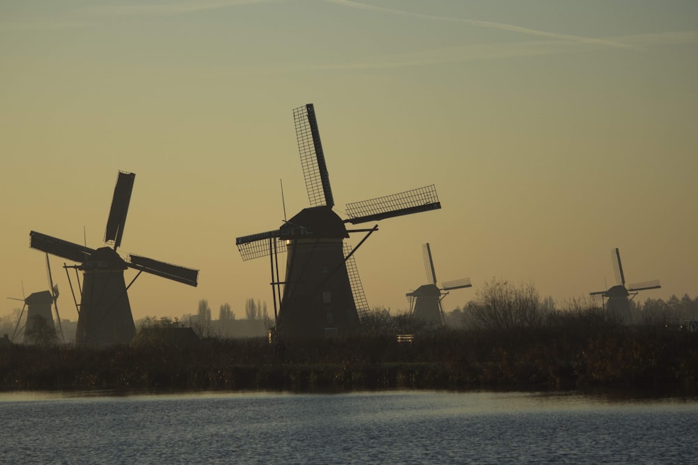 windmill near body of water during daytime