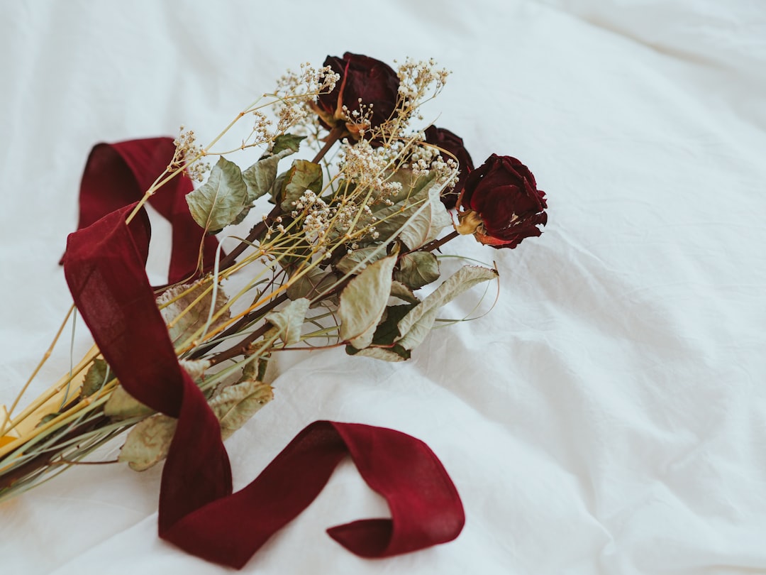 red and gold ribbon on white textile