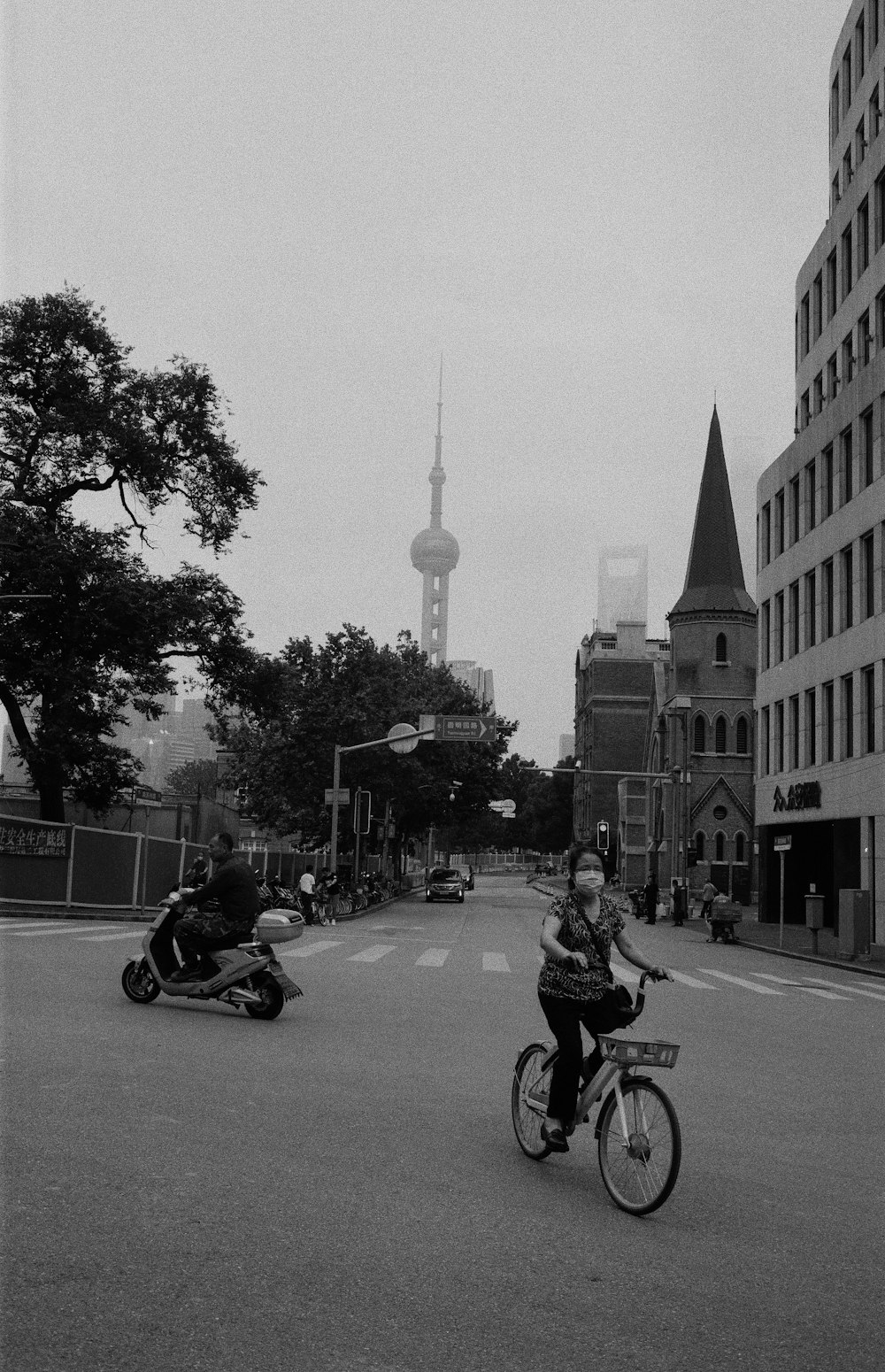 grayscale photo of man riding on motorcycle