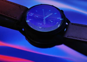 Auratime watch in vibrant turquoise with a matching strap displayed on a sunny windowsill.