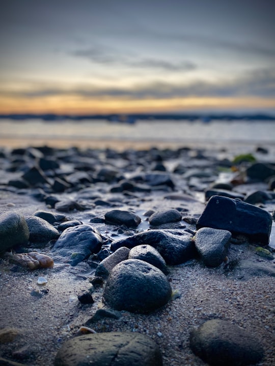 black stones on beach shore during sunset in Saint-Cast-le-Guildo France