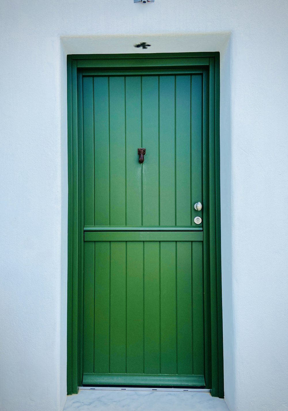 blue wooden door with red door knob