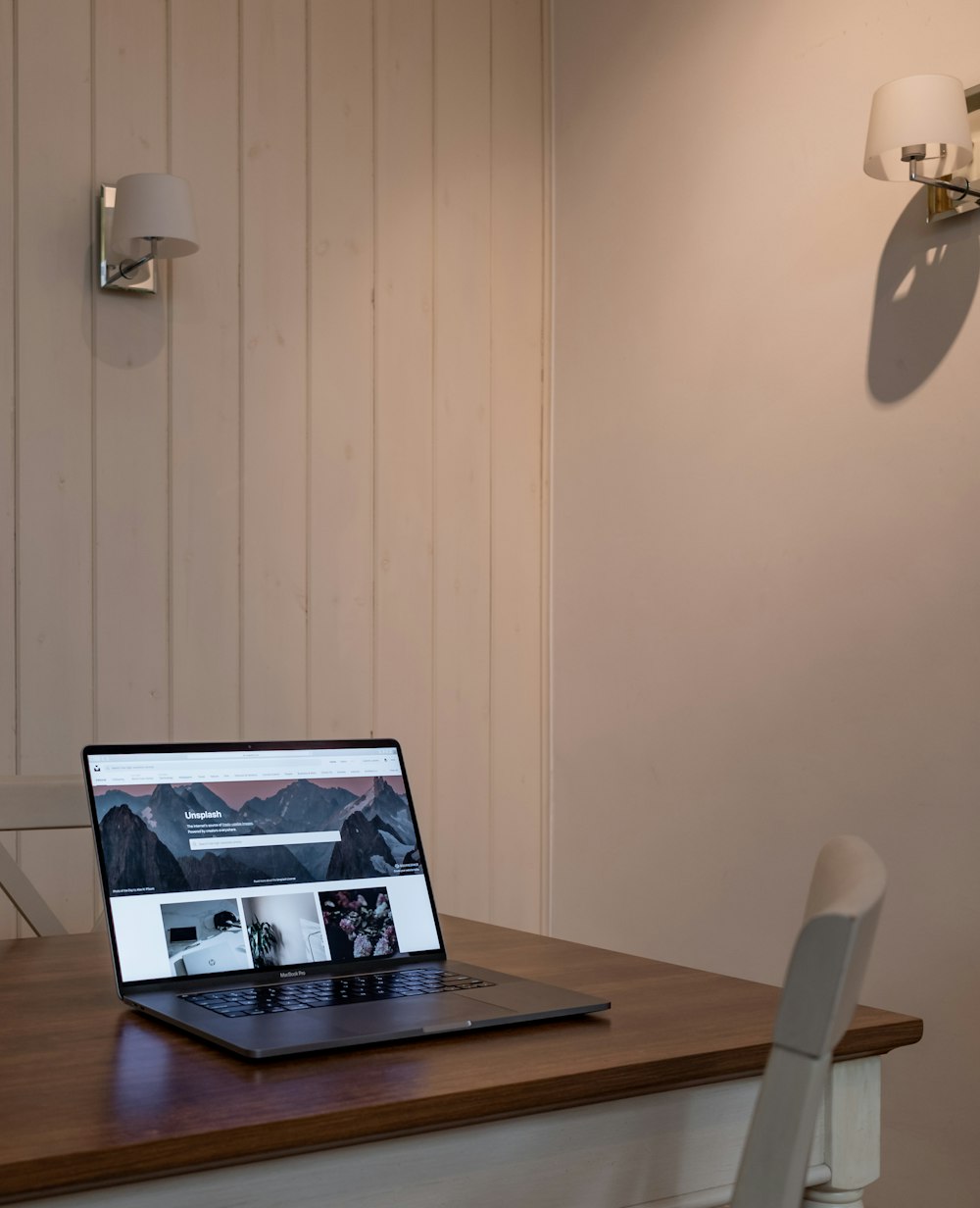 black laptop computer on brown wooden table