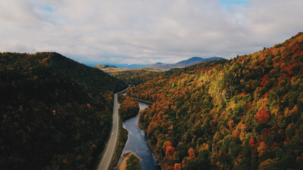 green and brown mountains beside road during daytime