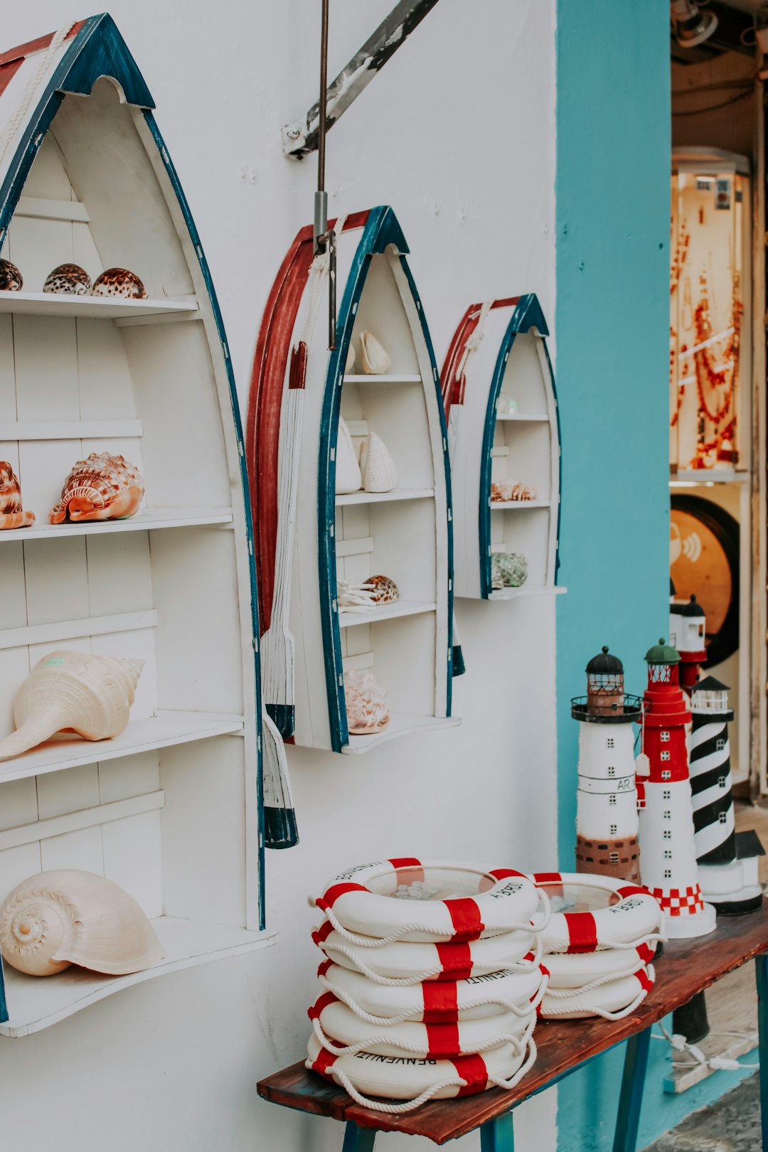 white and blue ceramic plates on white wooden shelf