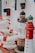 The image features several items with a nautical theme, including model lighthouses and stacked lifebuoys in white and red. The background contains blue and white decorations and a seashell.