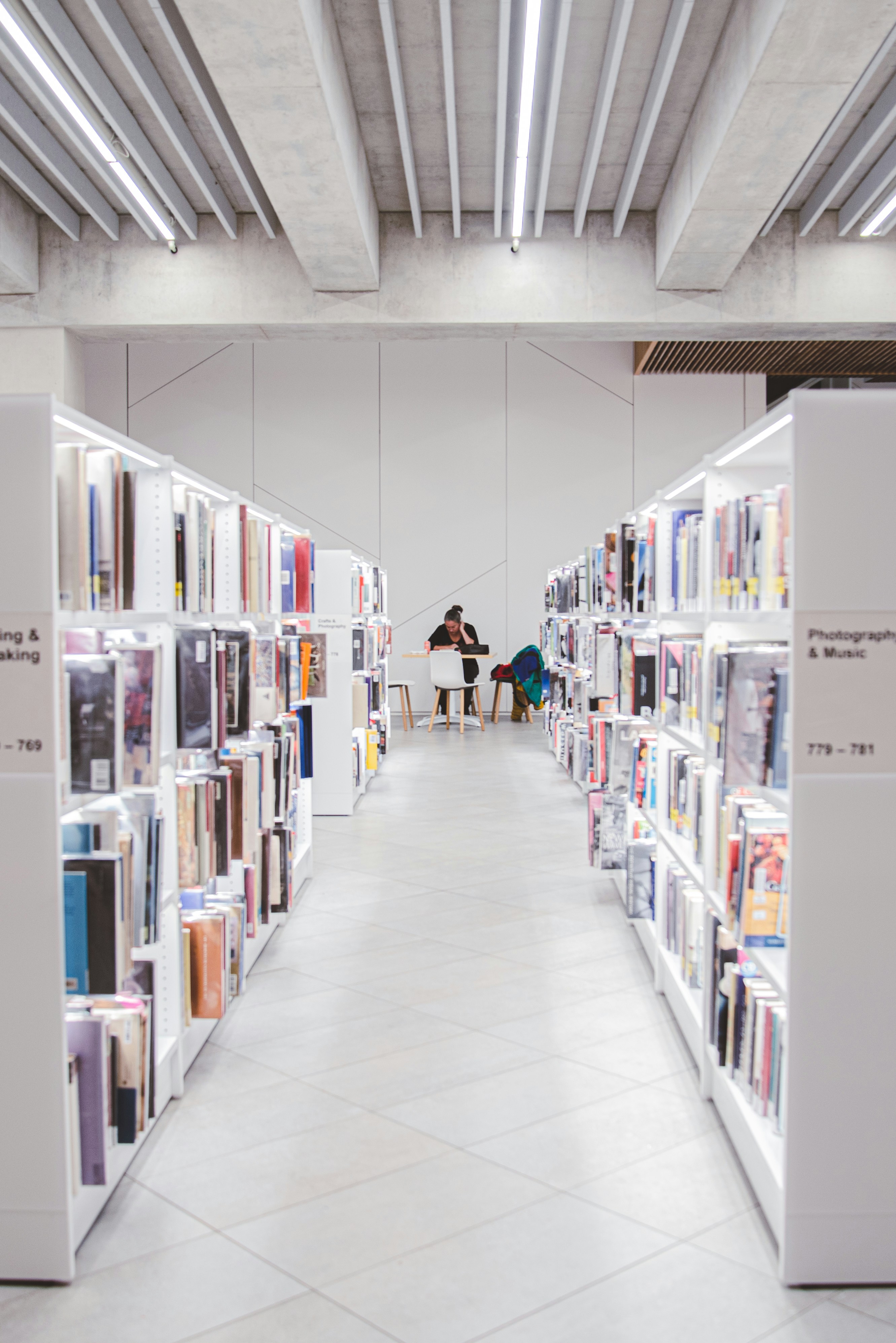 people walking on hallway inside library