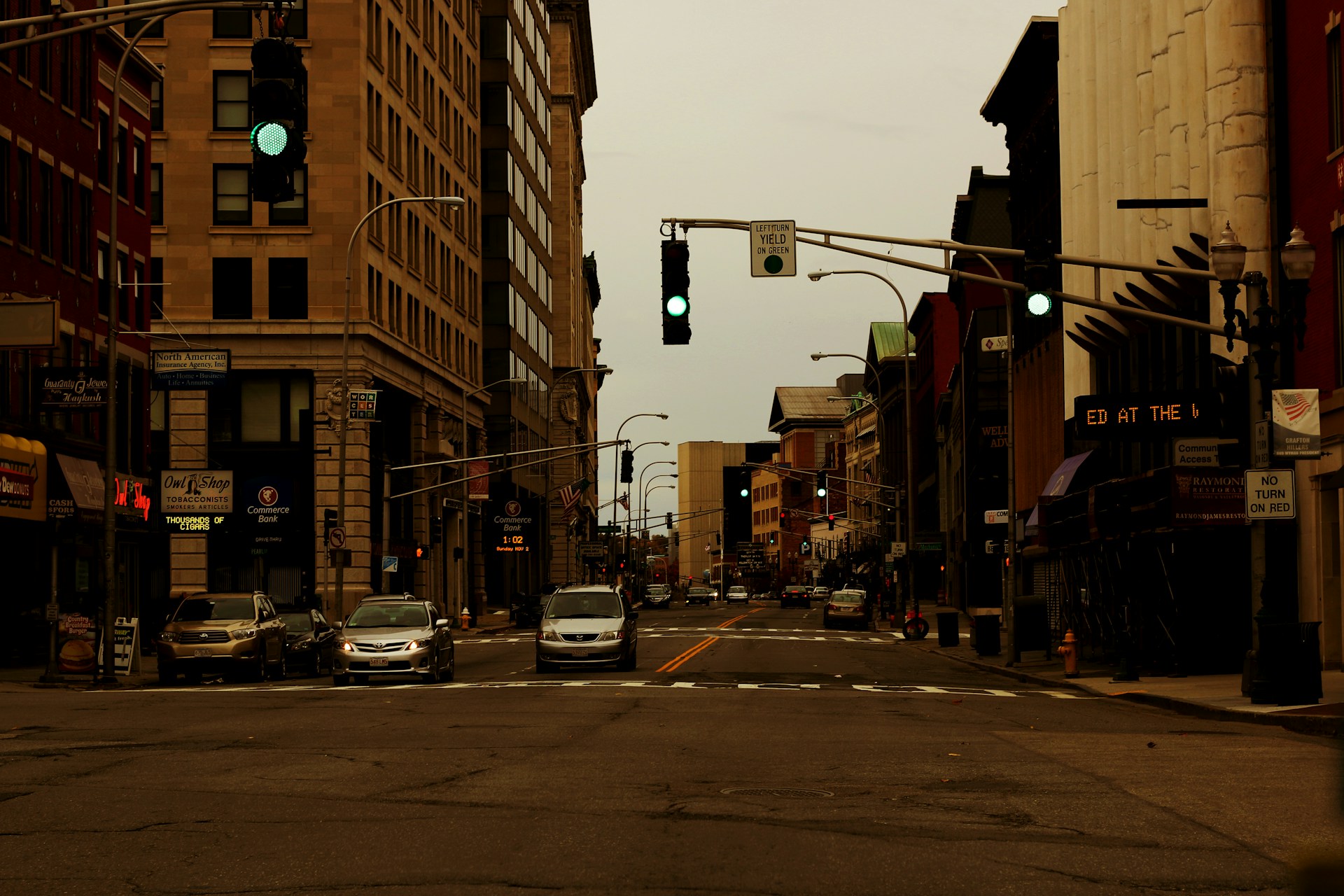 cars on road in between buildings during daytime