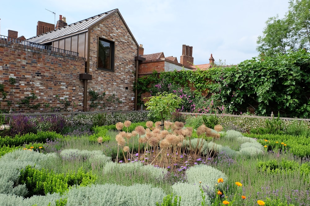 brown brick house near green grass field during daytime