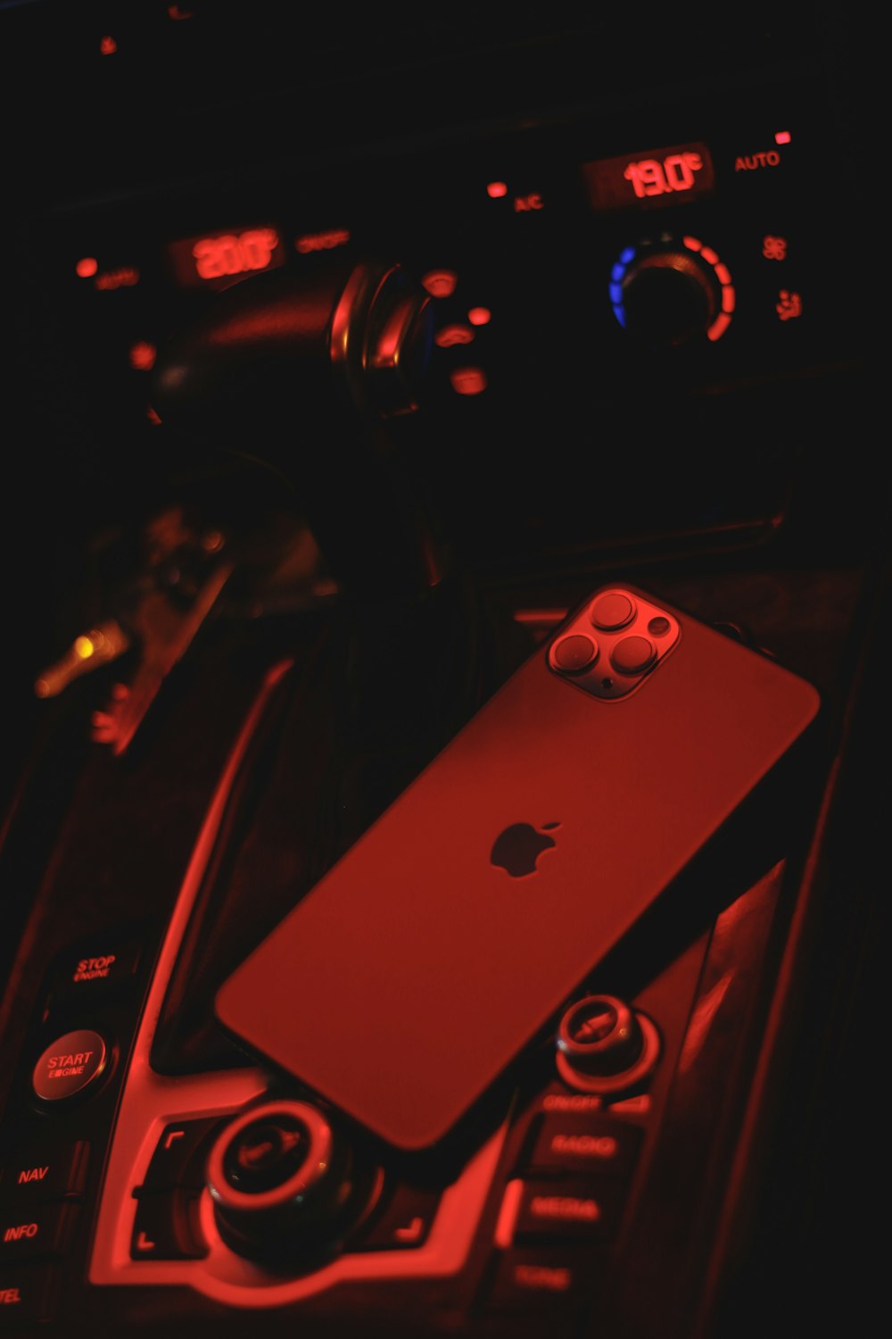 silver iphone 6 on black and red steering wheel