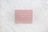 A pink pegboard with the words 'KINDNESS MATTERS' in white letters placed on a hexagonal tiled surface with a marble pattern.