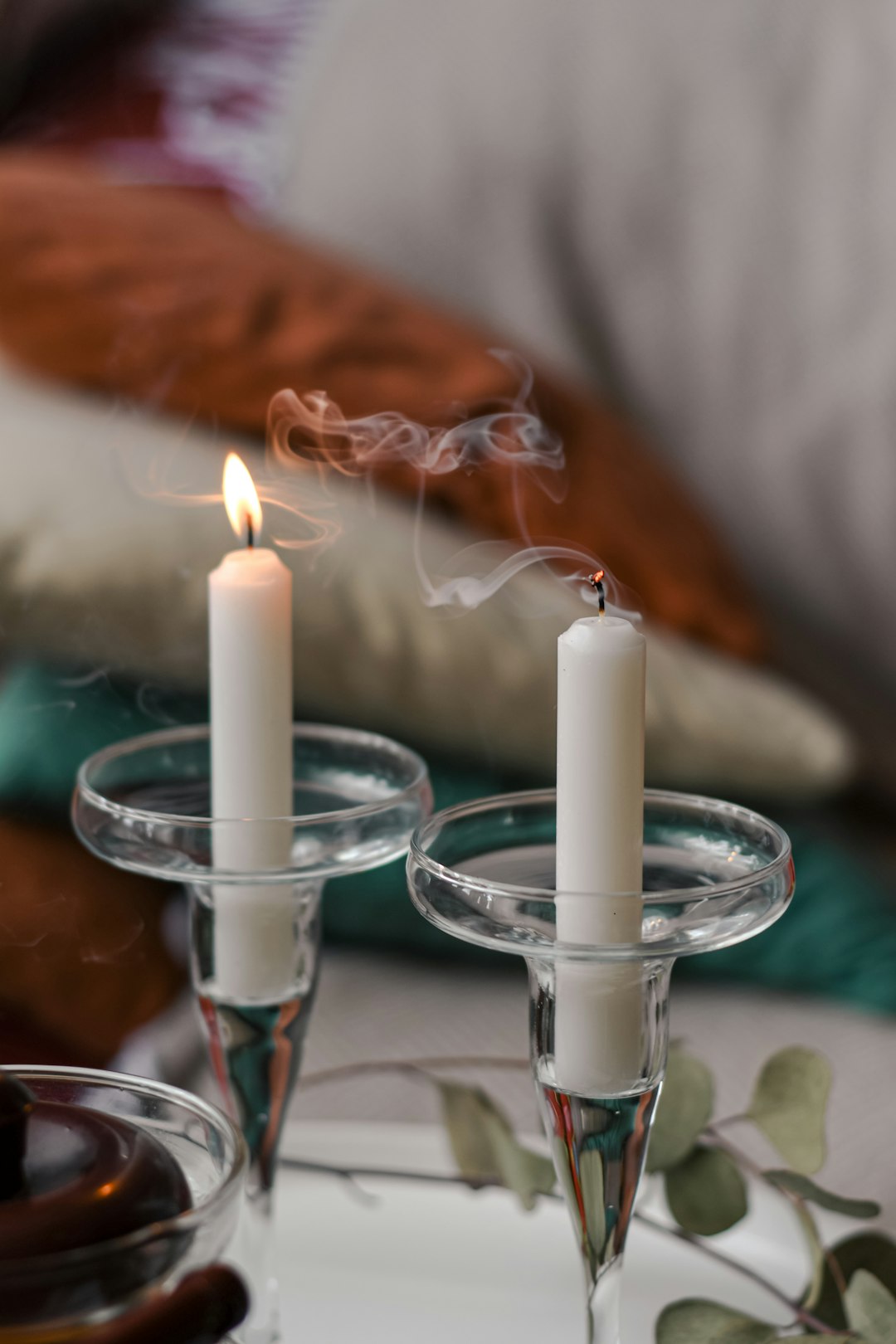 white candles on clear glass candle holder