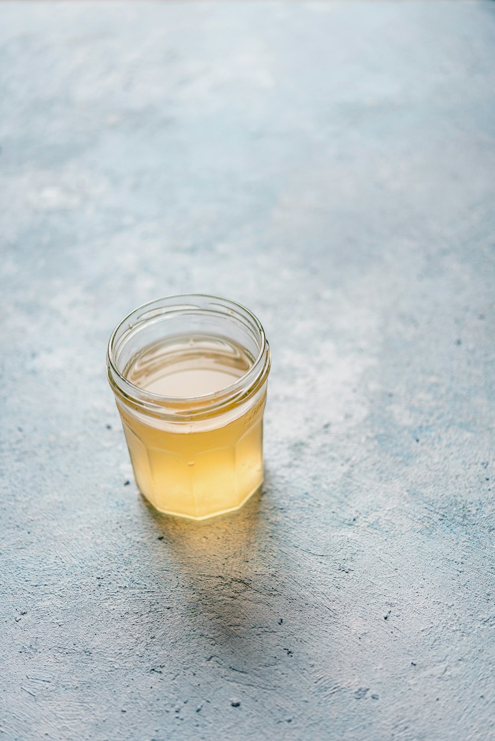 clear drinking glass with yellow liquid