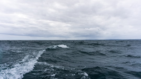 ocean waves under cloudy sky during daytime in Vättern Sweden