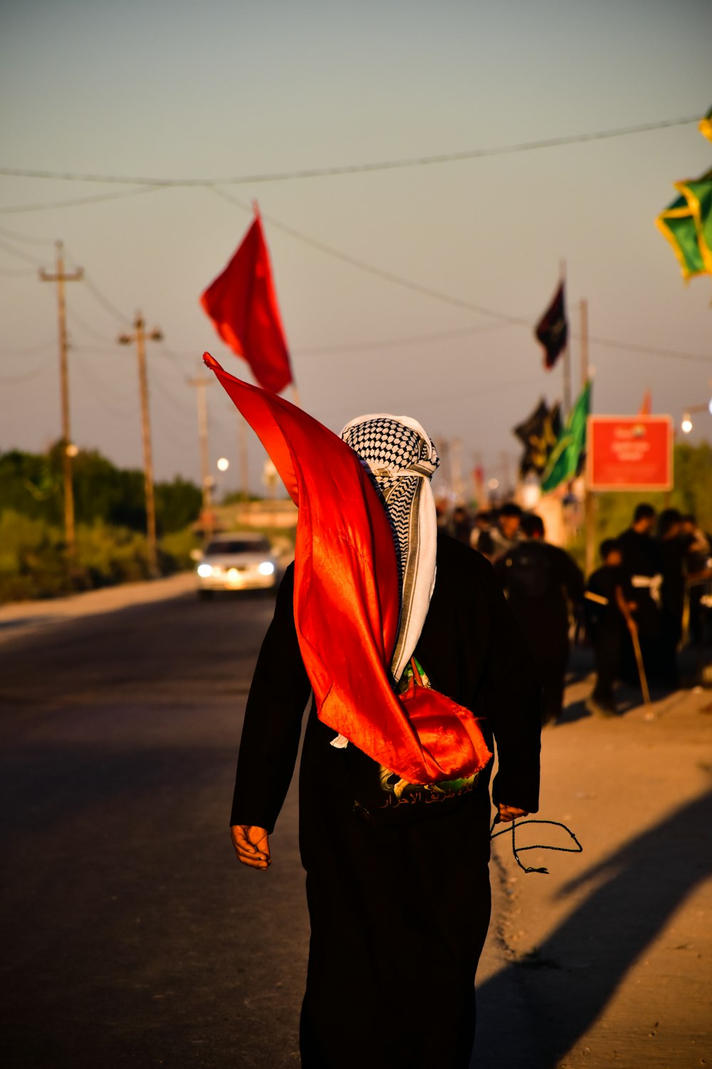 person in black long sleeve shirt wearing red and white scarf