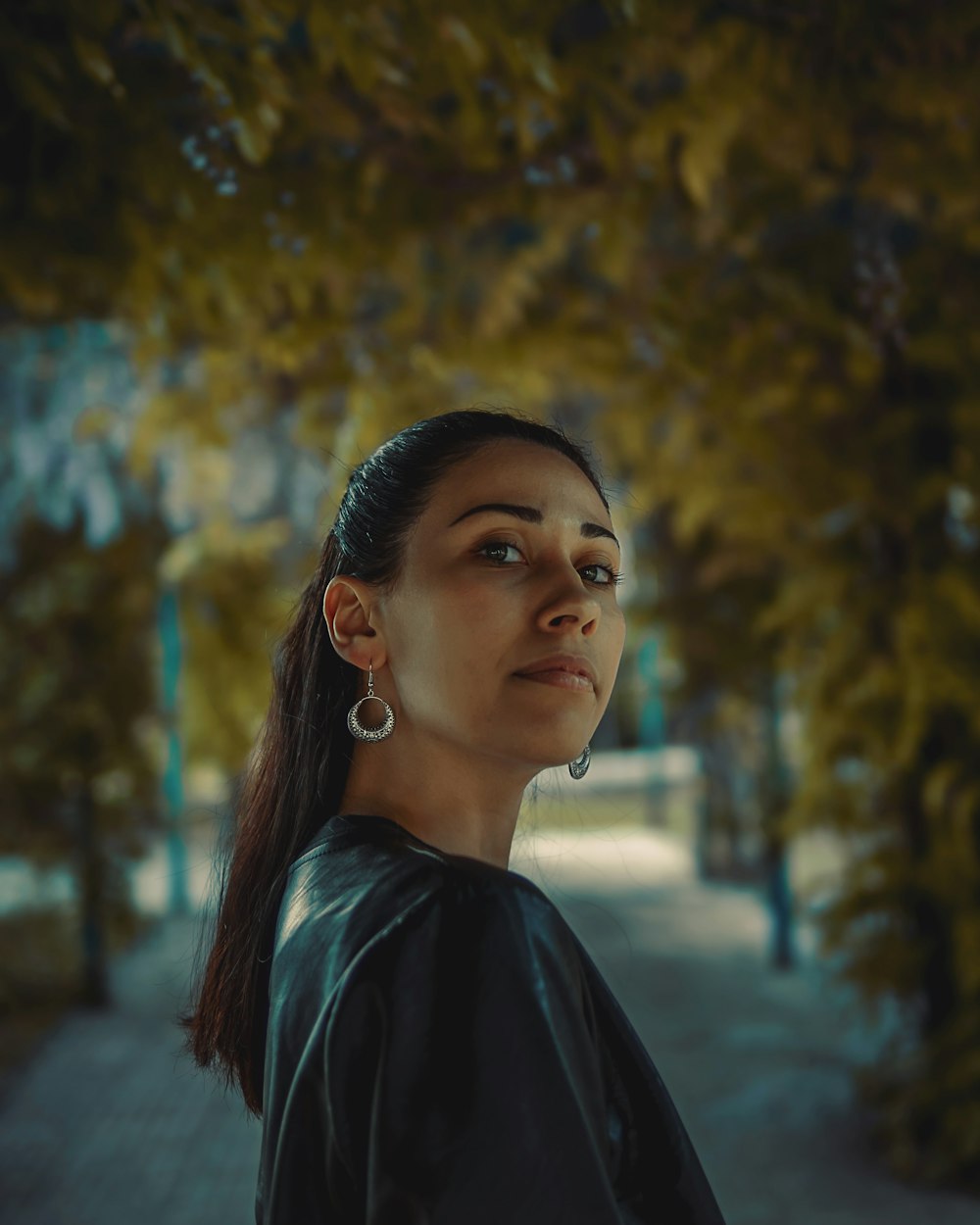 woman in black shirt standing near trees during daytime