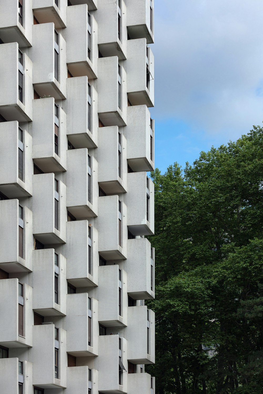 Edificio de hormigón blanco cerca de árboles verdes durante el día