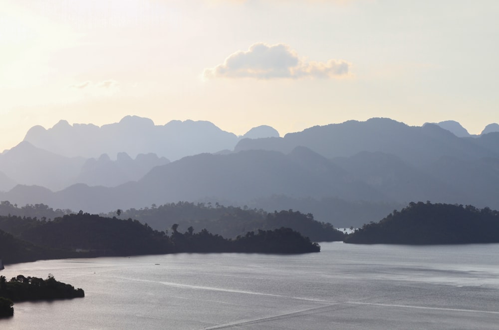 grayscale photo of mountains and body of water