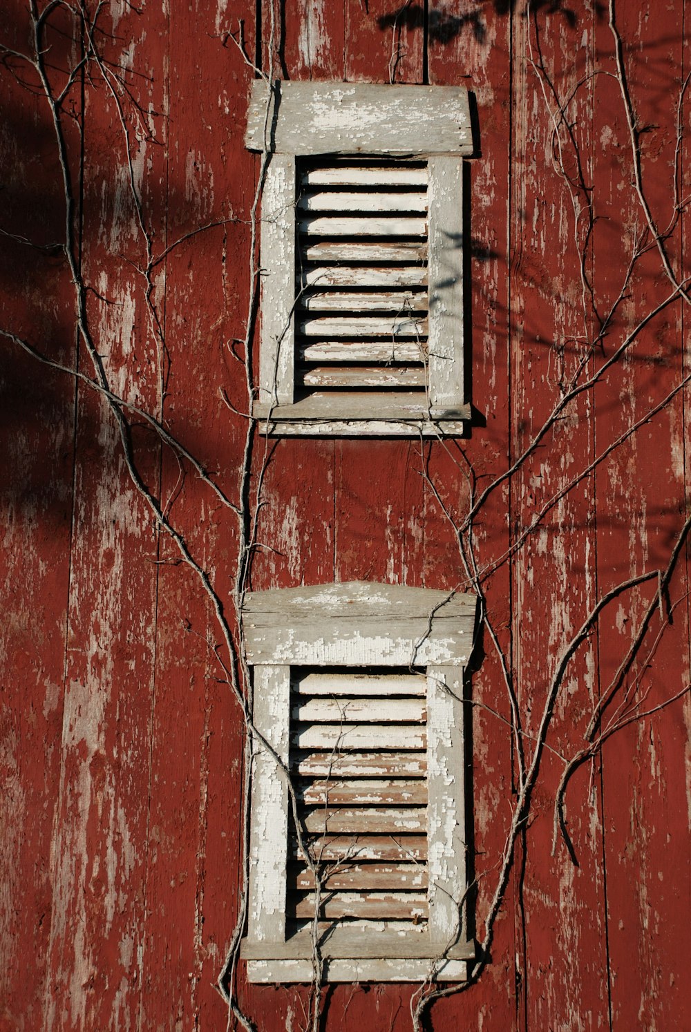 white wooden window on red concrete wall