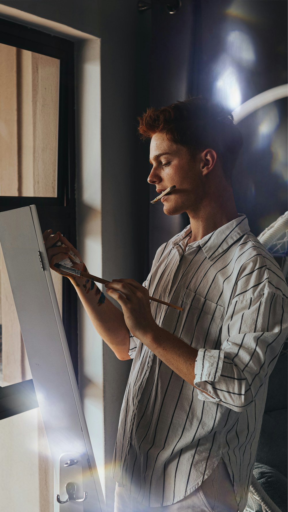 man in white and black plaid button up shirt holding tablet computer