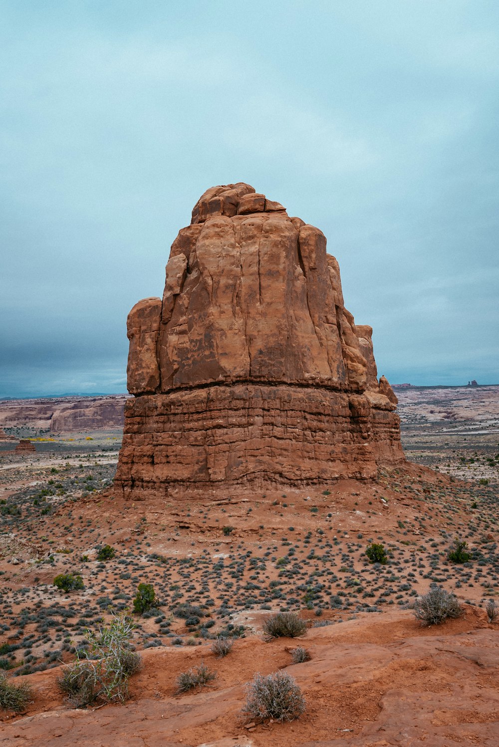 brown rock formation near body of water during daytime