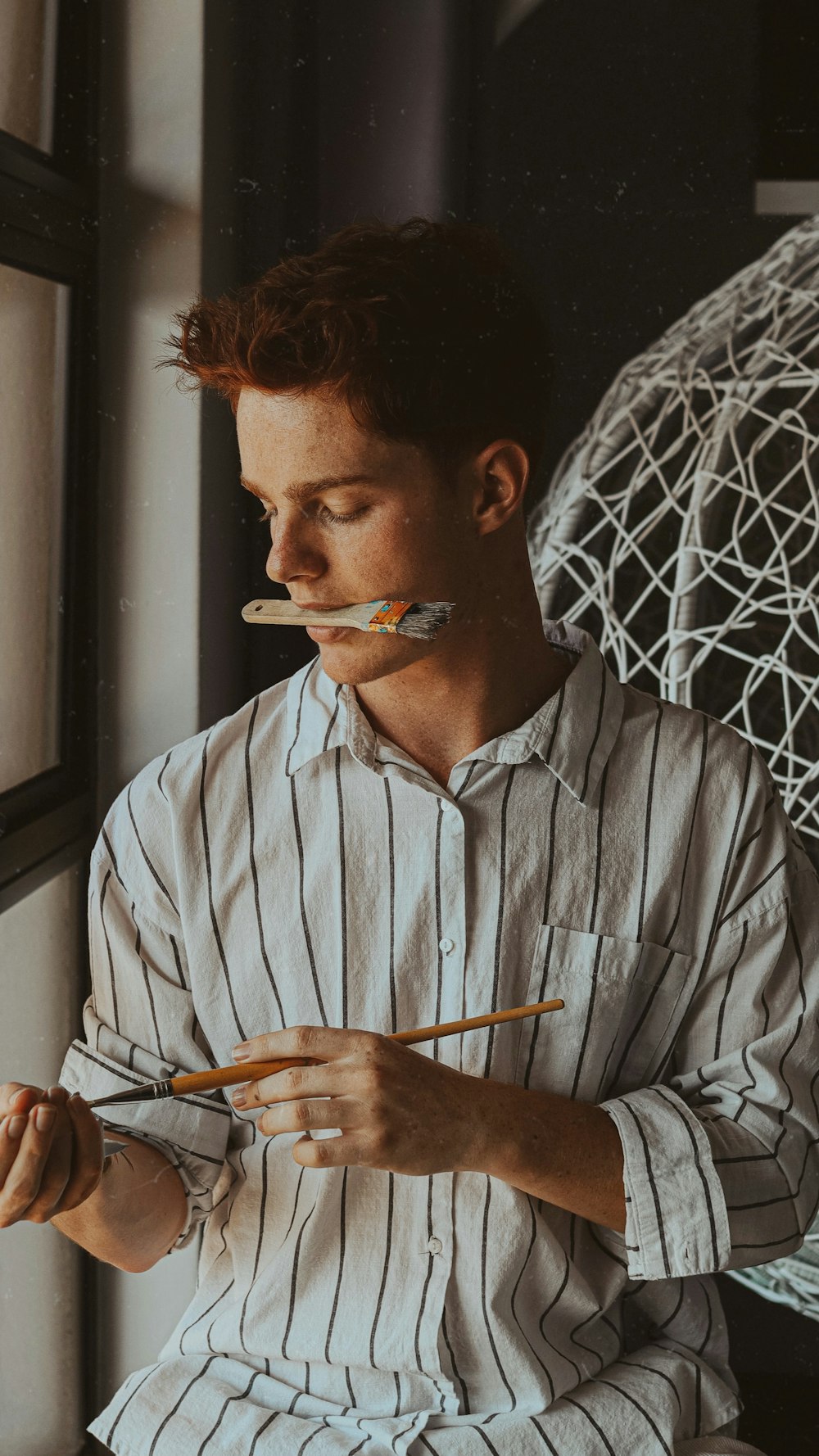 man in white dress shirt smoking cigarette