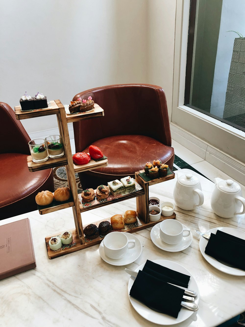 brown wooden tray with breads on white table