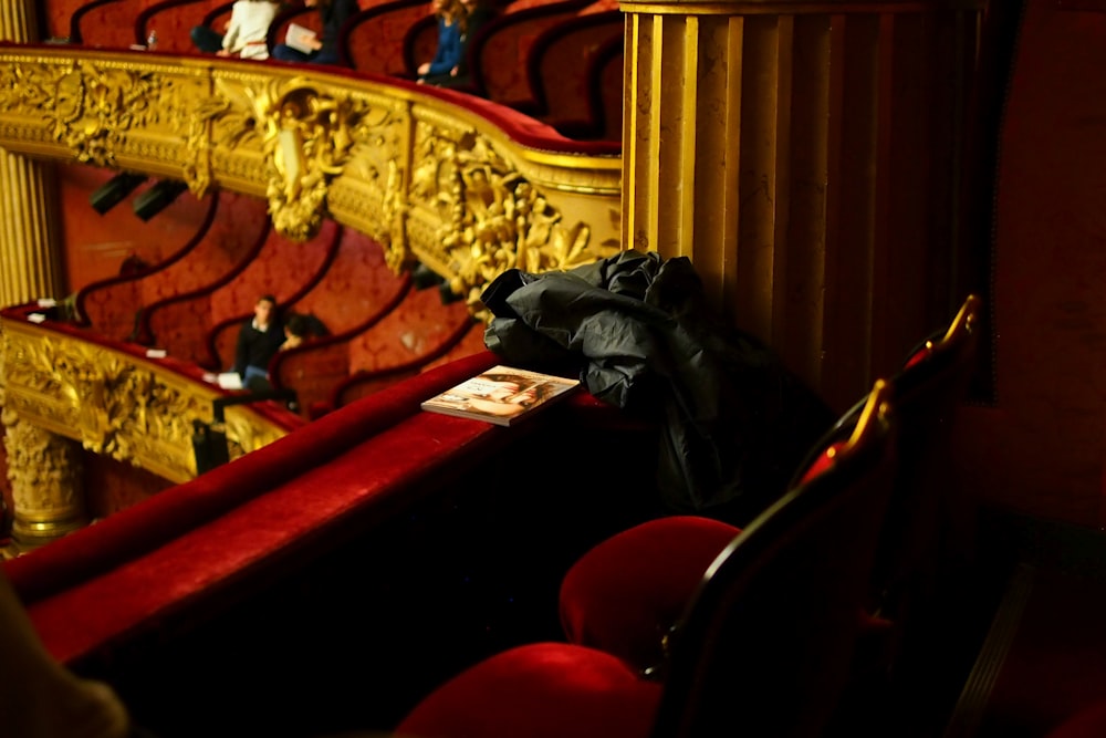 black leather jacket on red chair