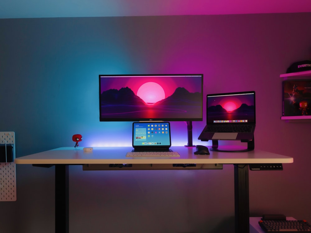 black flat screen computer monitor on brown wooden desk